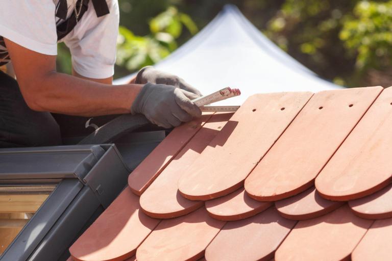 Expert roofer from Ron Bell Roofing installing a new roof in Delray Beach